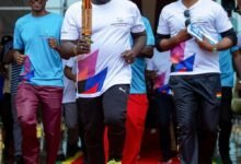 • Mr Debrah with the King's Baton. With him is the Director General of National Sports Authority (NSA), Yaw Ampofo Ankrah