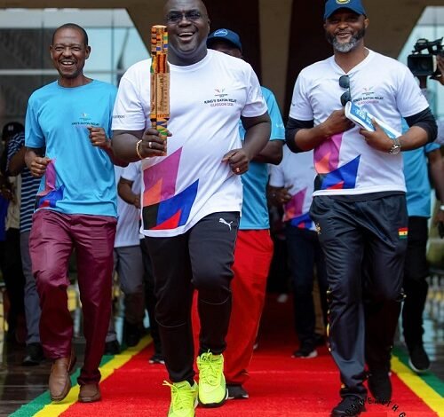 • Mr Debrah with the King's Baton. With him is the Director General of National Sports Authority (NSA), Yaw Ampofo Ankrah