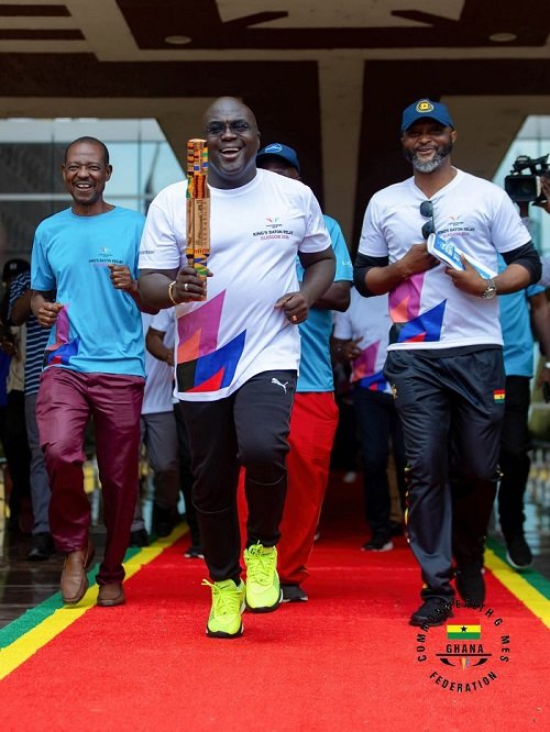 • Mr Debrah with the King's Baton. With him is the Director General of National Sports Authority (NSA), Yaw Ampofo Ankrah