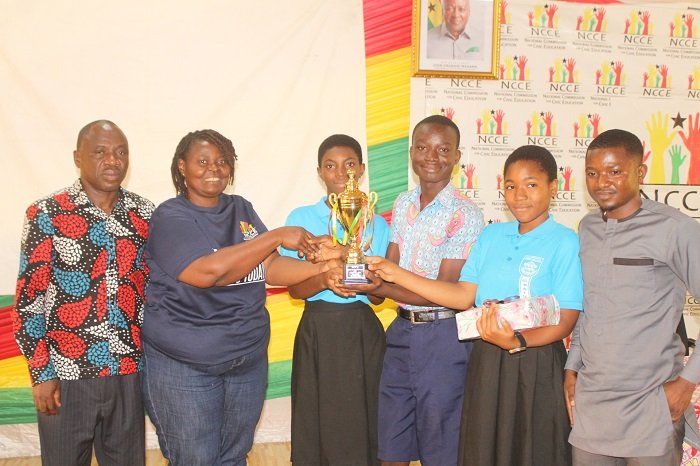 Mrs Gloria A. Kudo (left) presenting the winner trophy to all Saints Anglican Model Basic School. Photo: Ebo Gorman