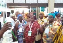 • Dr Otukunor (in smock) being briefed at one of the exibition stands