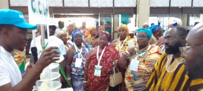 • Dr Otukunor (in smock) being briefed at one of the exibition stands