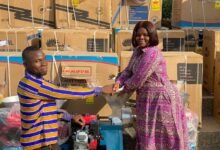 • Ms Akabila right) presenting an item to one of the beneficiaries