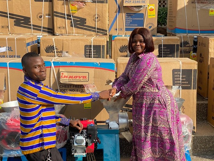 • Ms Akabila right) presenting an item to one of the beneficiaries