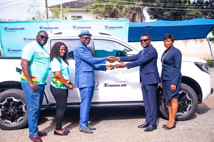 • Dr Addai-Poku (third from left) presenting the keys to Ms Grace Duah