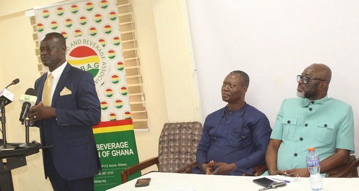 Rev. John Awuni (standing) addressing the press conference. With him include Mr Joseph Obeng (right) GUTA President Photo: Ebo Gorman