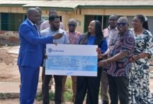 Ms Jackline Osei-Kusi (middle) presenting the cheque to Dr Bukari Zakari