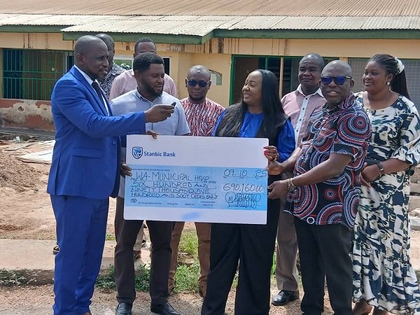 Ms Jackline Osei-Kusi (middle) presenting the cheque to Dr Bukari Zakari