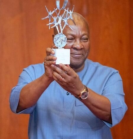 President Mahama showing the trophy
