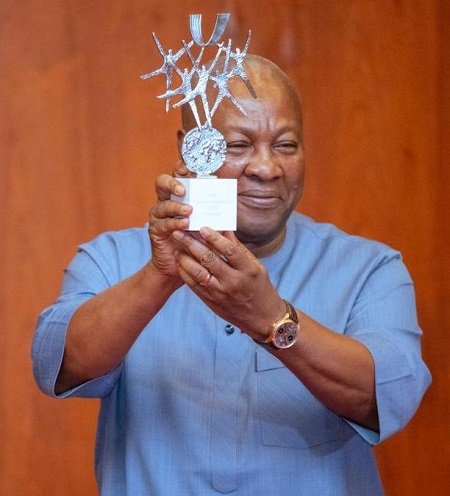 President Mahama showing the trophy