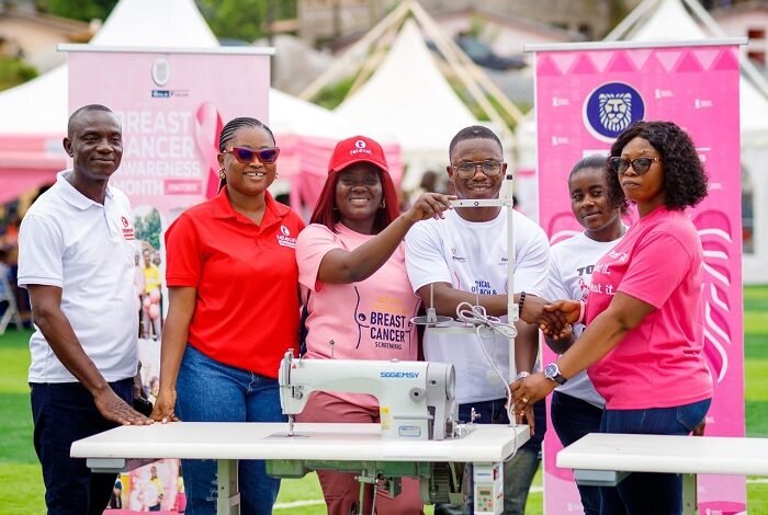 • Officials of the two institutions with the sewing machines