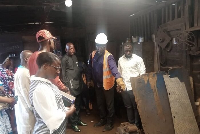 • Mr Saani Adams (third from right) being briefed by an operator at a workshop
