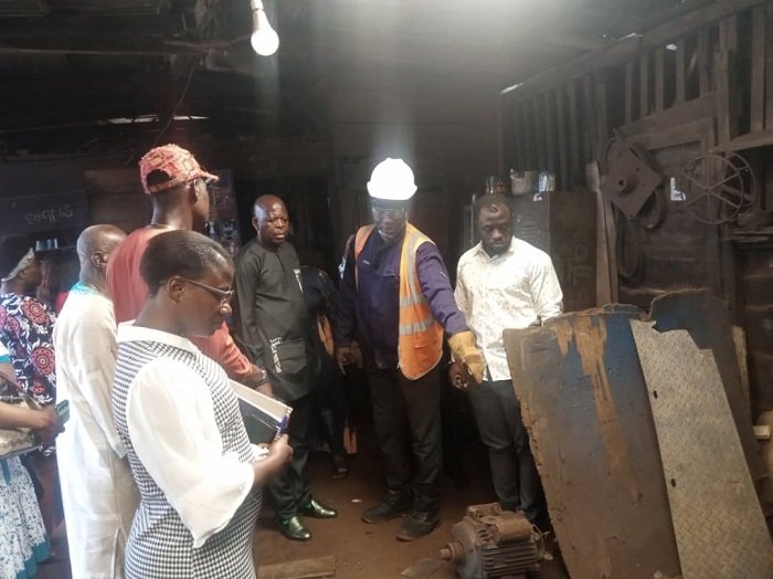 • Mr Saani Adams (third from right) being briefed by an operator at a workshop