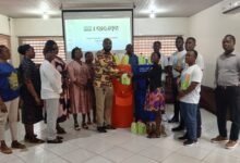 • Ms Hagan (right) presenting hand-washing items to George Nuertey Awingam (Presiding Member of KKMA)