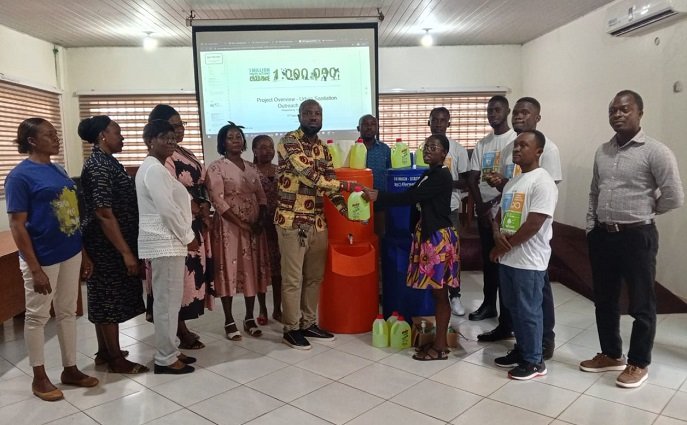 • Ms Hagan (right) presenting hand-washing items to George Nuertey Awingam (Presiding Member of KKMA)