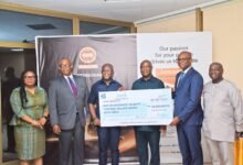 Mr. Aklasi (second from right) presenting the dummy cheque to Prof. Kpessa-Whyte (third from left)