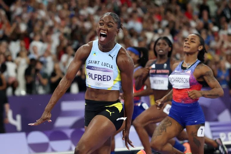 2024 Paris Olympic women's 100m champions Julien Alfred celebrates ahead of Sha'Carri Richardson and Melissa Jefferson