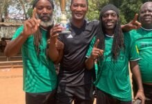 • Arthur Moses (second left) and colleagues celebrating with the trophy