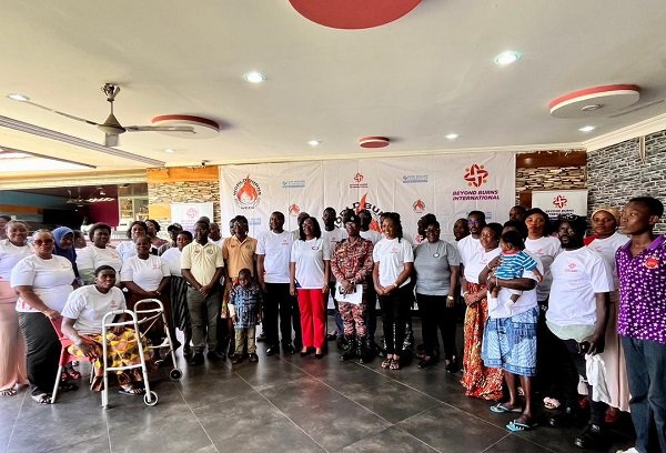 Ms Judith Cato Addison (sixth from right) and Ms Alberta Emissah Nyarko (sixth from left) with other dignitaries and burn survivors at the programme