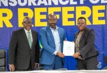 Mr Simeon-Okraku presenting the policy to Madam Christine Enyonam Zigah, Chairperson of the GFA's Referees Appointment Committee. With them is Mr Hodasi