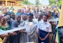 • Mr Haruna Iddrisu (middle) being assisted by Ms Helga Josephine Miranda Boadi to cut the tape to open the facility
