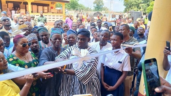 • Mr Haruna Iddrisu (middle) being assisted by Ms Helga Josephine Miranda Boadi to cut the tape to open the facility