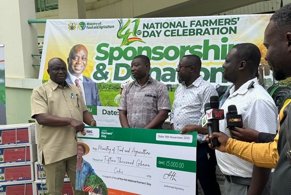 • Mr Opoku receiving a dummy cheque from RMG executives