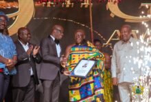 A colleague reporter receiving the overall journalist of the year award on behalf of Godwin Asediba from Asantehene, Otumfuo Osei Tutu II. Looking on is President Mahama