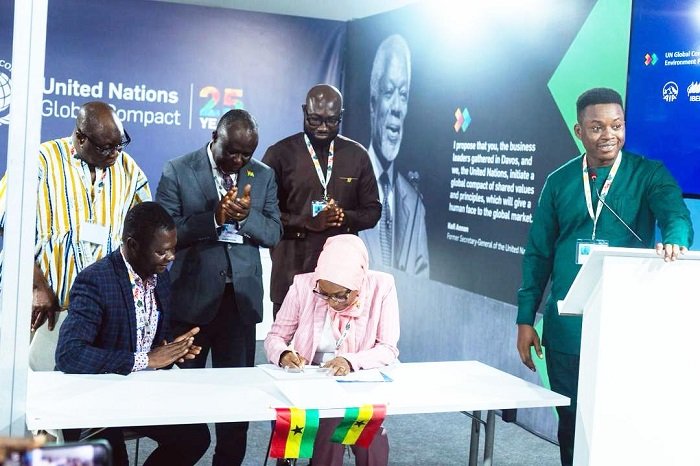 • Prof. Fatima Denton (right) signing the MoU, witnessed by Dr Glenn Kwabena Gyimah, with members of the Parliamentary Select Committee on Environment looking on
