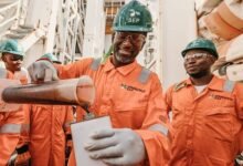 • Kevin Okyere pouring out a sample of the discovered crude oil in 2019