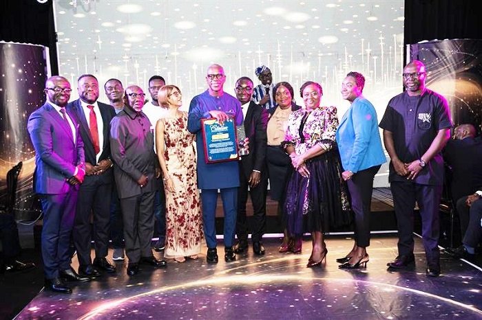 • Mr Effah (middle) displaying the award