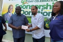 Mr Eric Opoku (left) receiving a cheque from a representative of Interplast