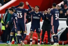PSV Eindhoven's Couhaib Driouech celebrates scoring their fourth goal with teammates