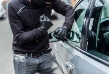 A man breaking into a car