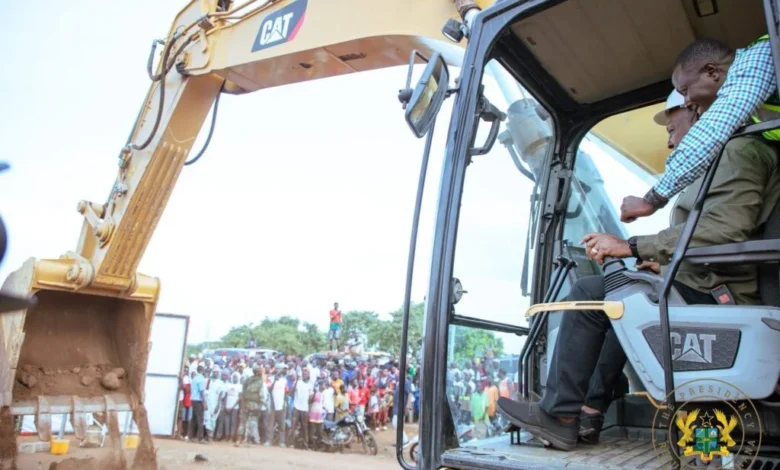 -President Mahama being assisted to cut sod for the road constructio