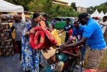 • Naa Torshie presenting items to beneficiaries