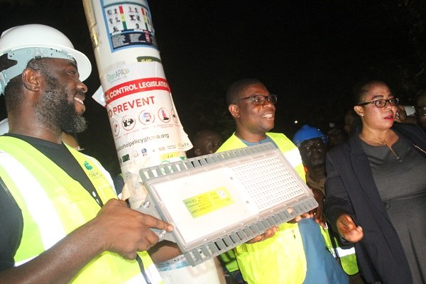 • Mr Gyan-Mensah (middle) and Ms Linda Ocloo (right) symbolically handing over one of the street lights to Mr Augustine Baidoo (left) Photo: Ebo Gorman
