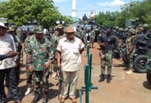 Mr Genfi (second from left)being briefed on the use of some of the weapons