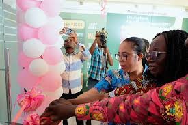 Ms Ocloo (right) being assisted to cut tape to open the facility