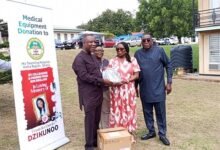 Mrs Maginn (second right presenting one of the monitors to Mr Tetteh.