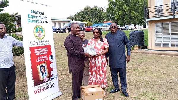Mrs Maginn (second right presenting one of the monitors to Mr Tetteh.