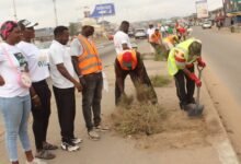 • Mr Badger with (shovel) MCE, ONMA leading the cleaning exercise. Photo: Ebo Gorman
