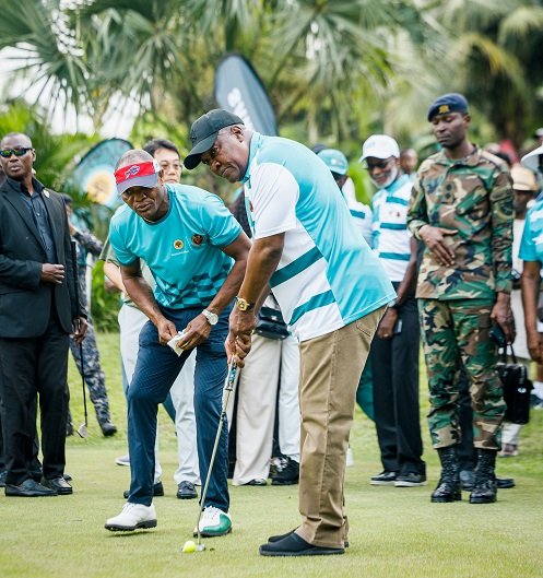 A focused President Mahama meticulously eyes the line to the hole before hitting the ball