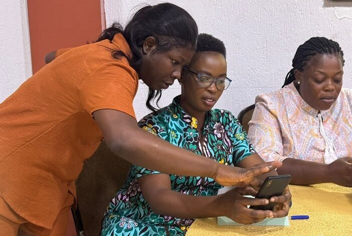 Ms Laryea (left) taking some of the participants through the reading process