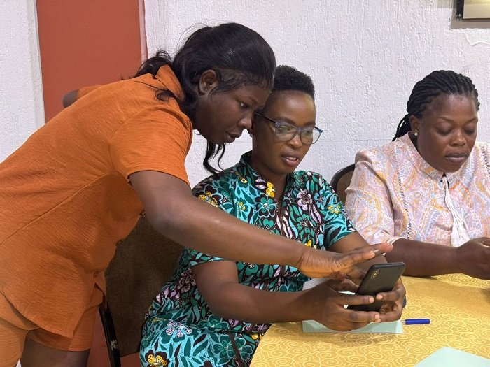 Ms Laryea (left) taking some of the participants through the reading process