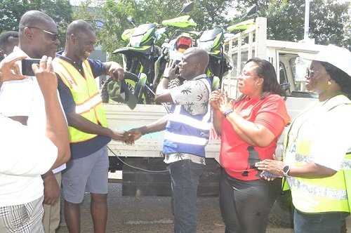 • Mr Anyetei (second from left) handing over the motorbikes to Mr Okumetey. With them is Ms Ocloo Photo: Victor A. Buxton