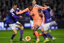 Barcelona's Marcus Rashford is challenged by his opponents during the game