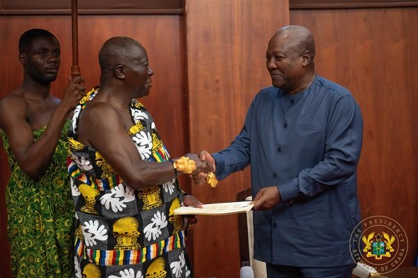 • President Mahama (right) receiving the report from Otumfuo Osei Tutu II