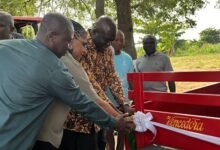 • Ms Myriam Montrat (middle), Mr Opoku (third from left) cutting a ribbon to officially hand over the equipment