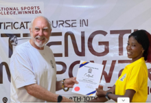 • Dr Kyle Pierce presenting a certificate to one of the graduating coaches